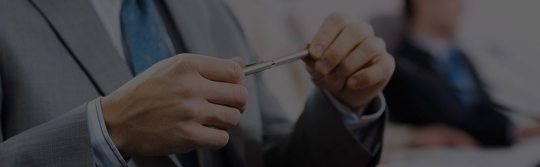 Man in Suit holding a pen