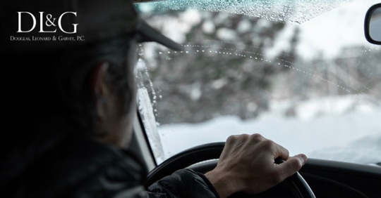 man driving through snow