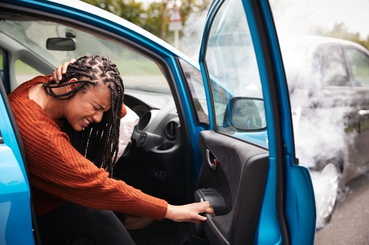 A women holding her neck after a car accident