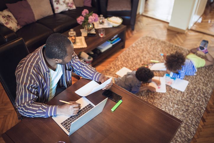 A man working from home while his kids play
